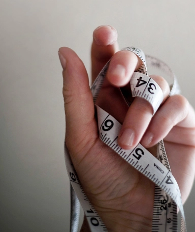 Hand holding measuring tape