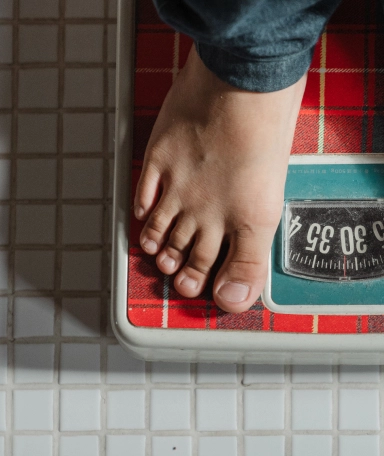 A person standing on a scale personal trainer